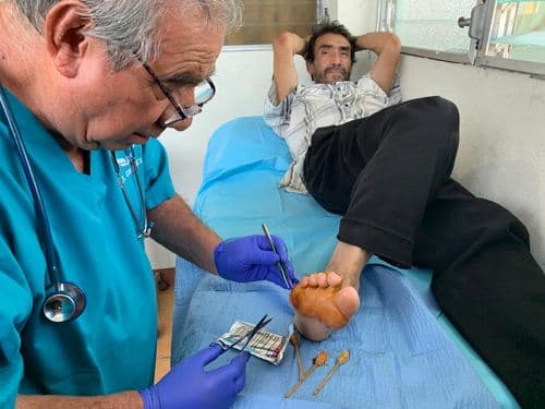 A CCCG medical team volunteer treating a patient